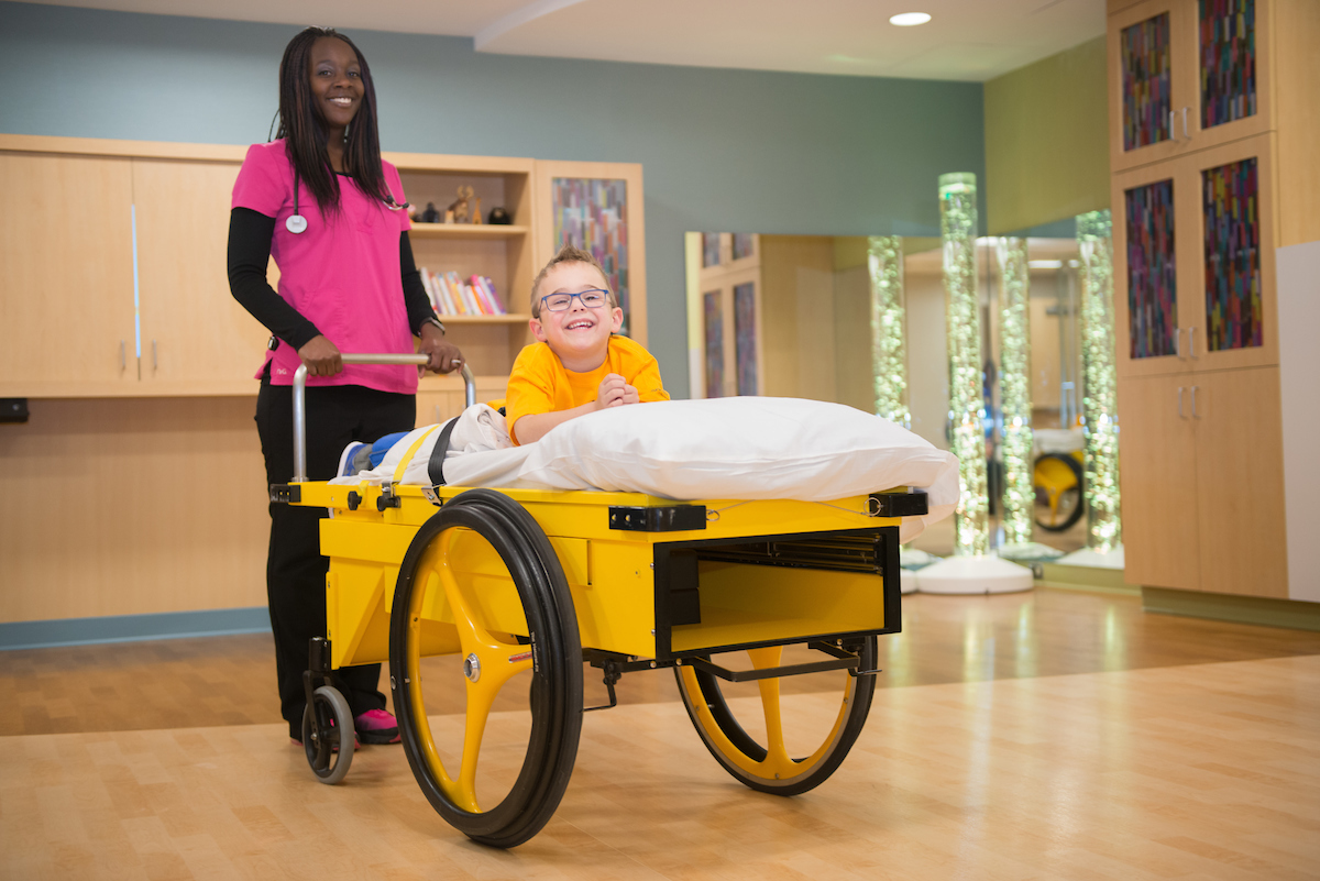 Children who have CP use a prone cart to recover after selective dorsal rhizotomy (SDR) surgery.