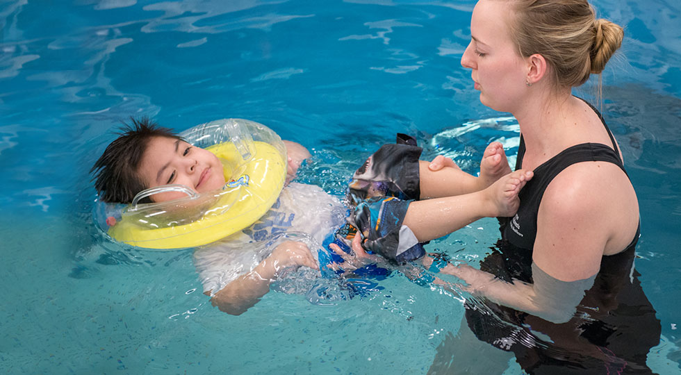 Physical therapist during aquatic pool therapy with Gillette patient. 