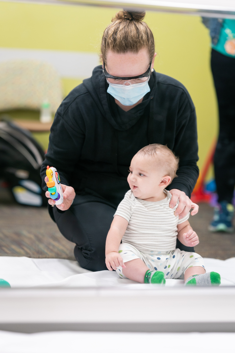 Isaiah Hanson works with his physical therapist to treat his torticollis.