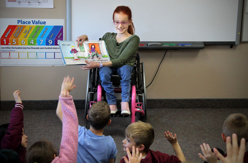 Maddy Lavalier reading to a class at her school