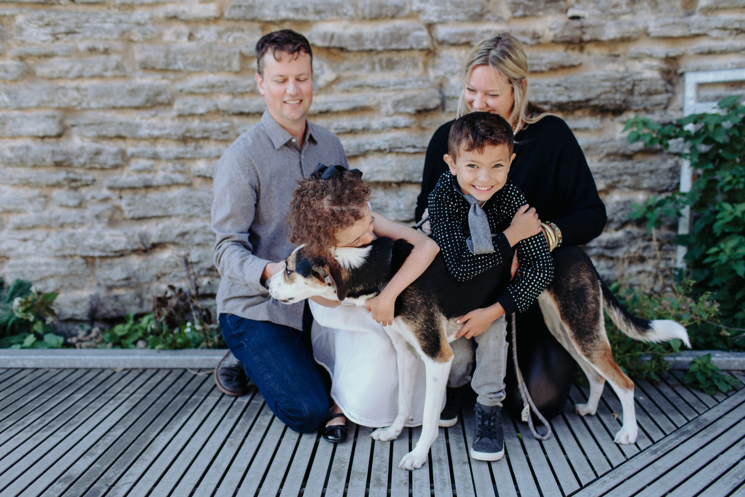 The Berkland family embracing their dog