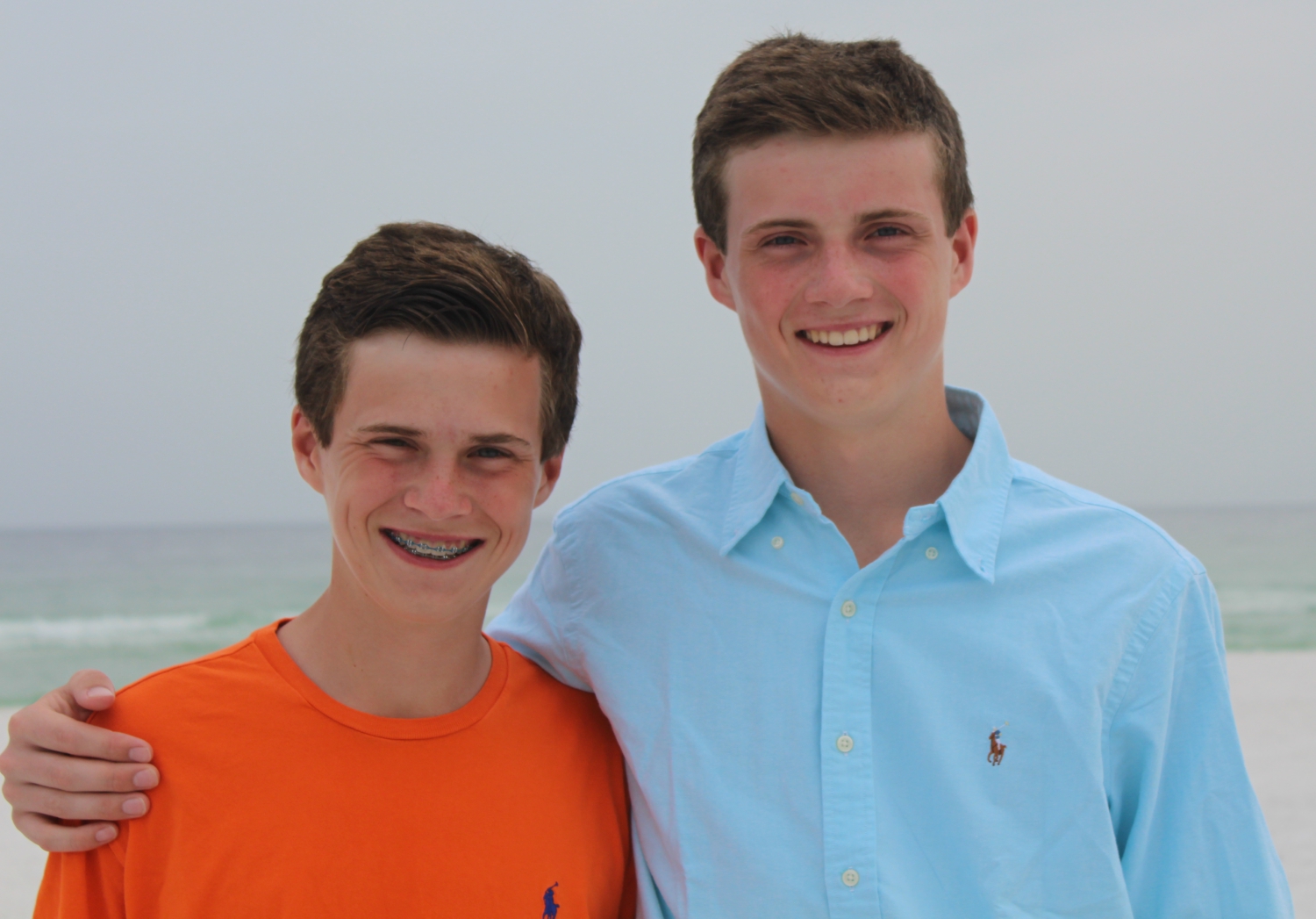 George and his brother Jack at a beach with the ocean in the background