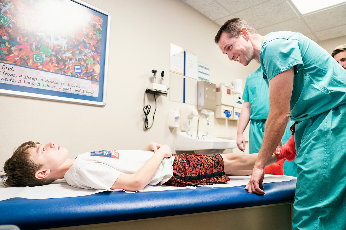 Dr Cooper with Gillette Children's patient Isaac Jacobson during an  appointment.