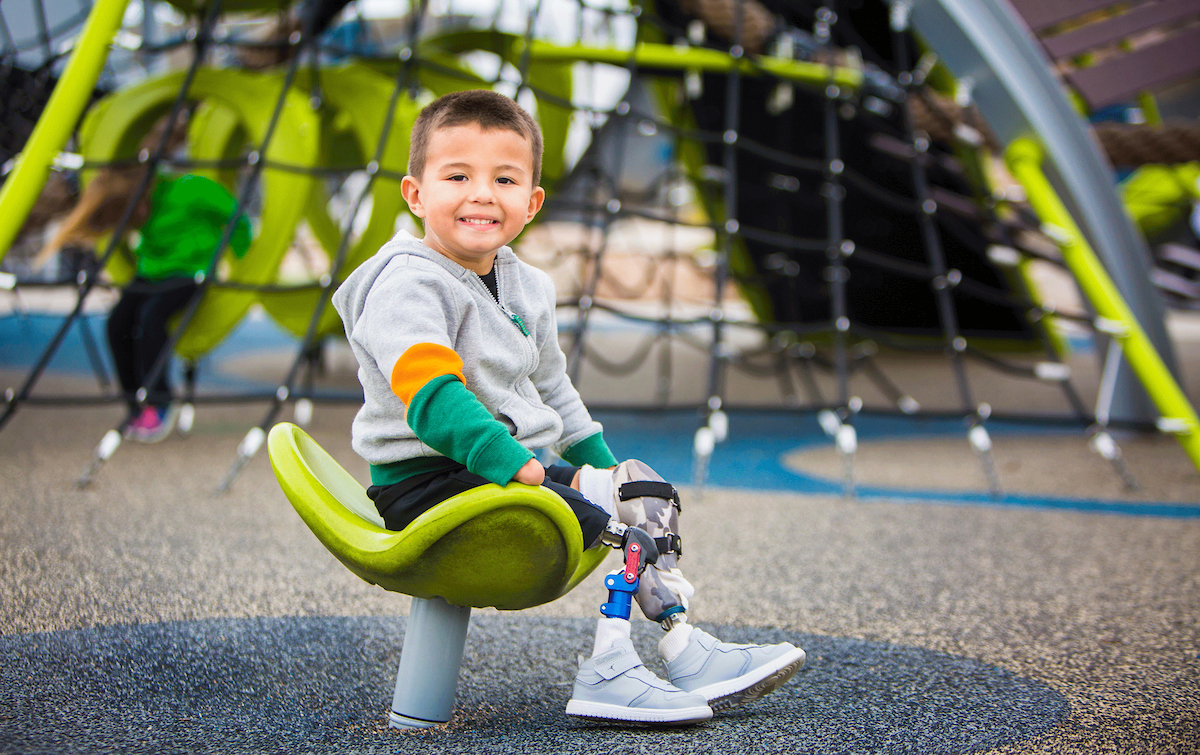 Complex care Gillette Children's patient Dominic plays at Playground in Twin Cities.