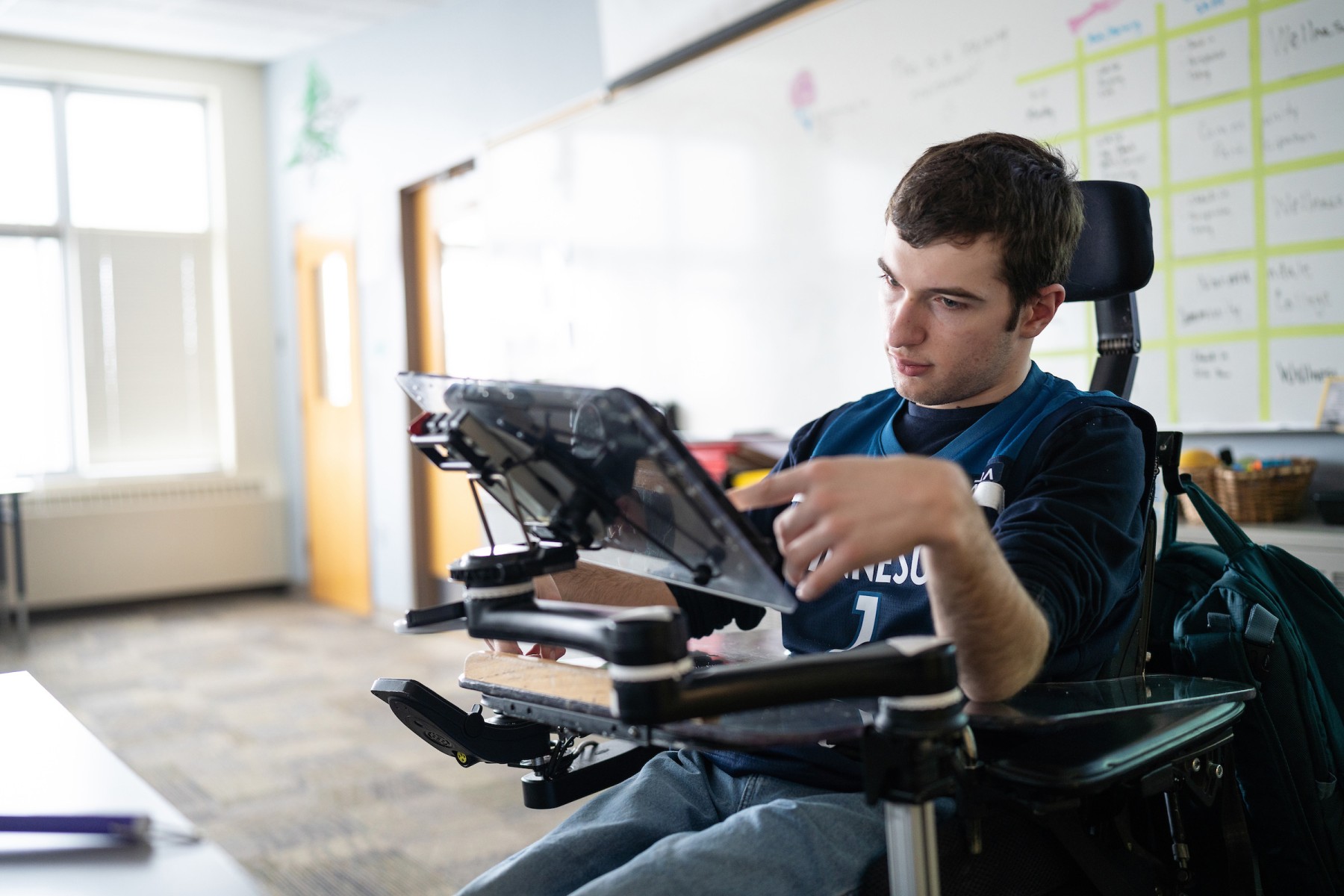 Joe Carr a patient of Gillette from Richfield in his classroom at Transition Plus working on augmentative and alternative communication tools and resources.