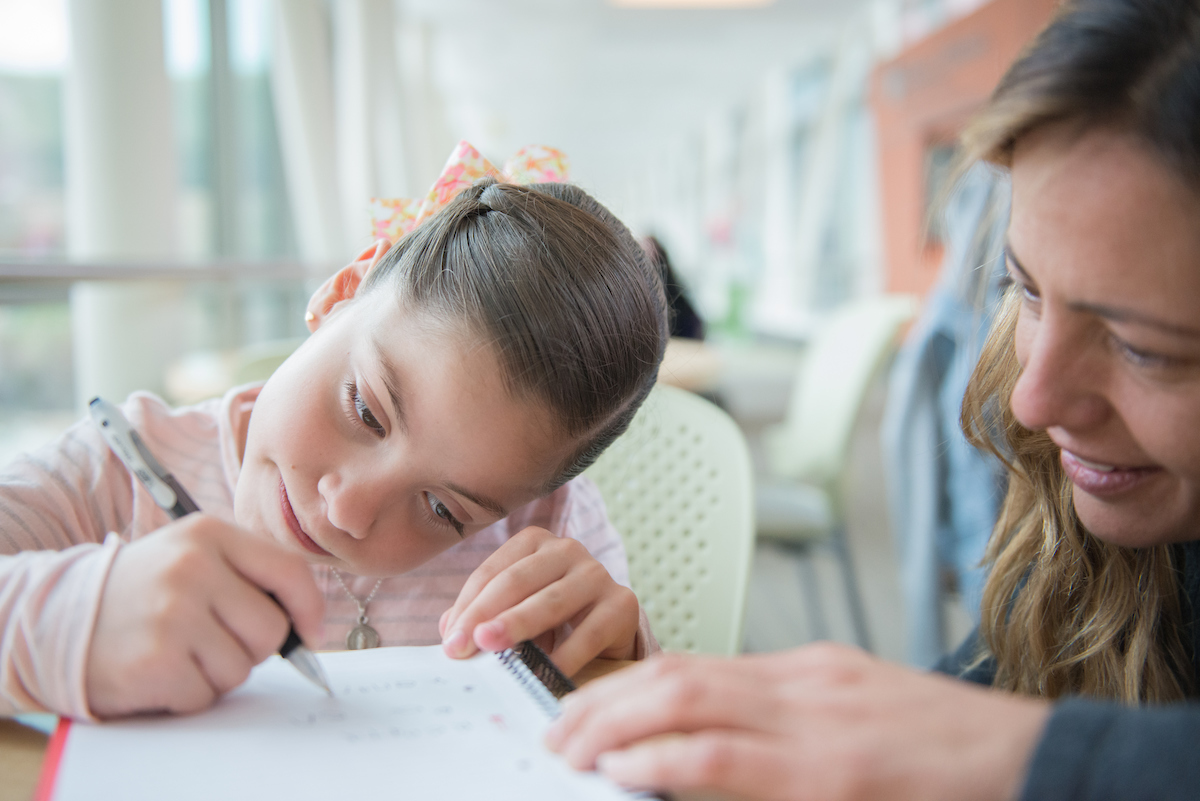 Gillette Children's patient is supported by caregiver.