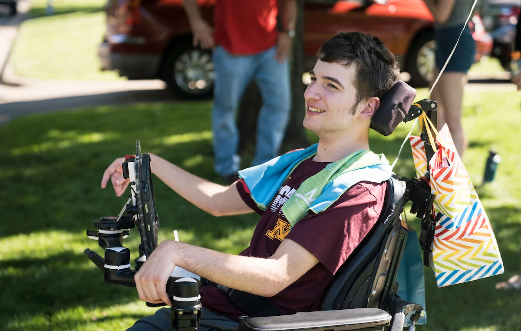Young man at park in wheelchair.