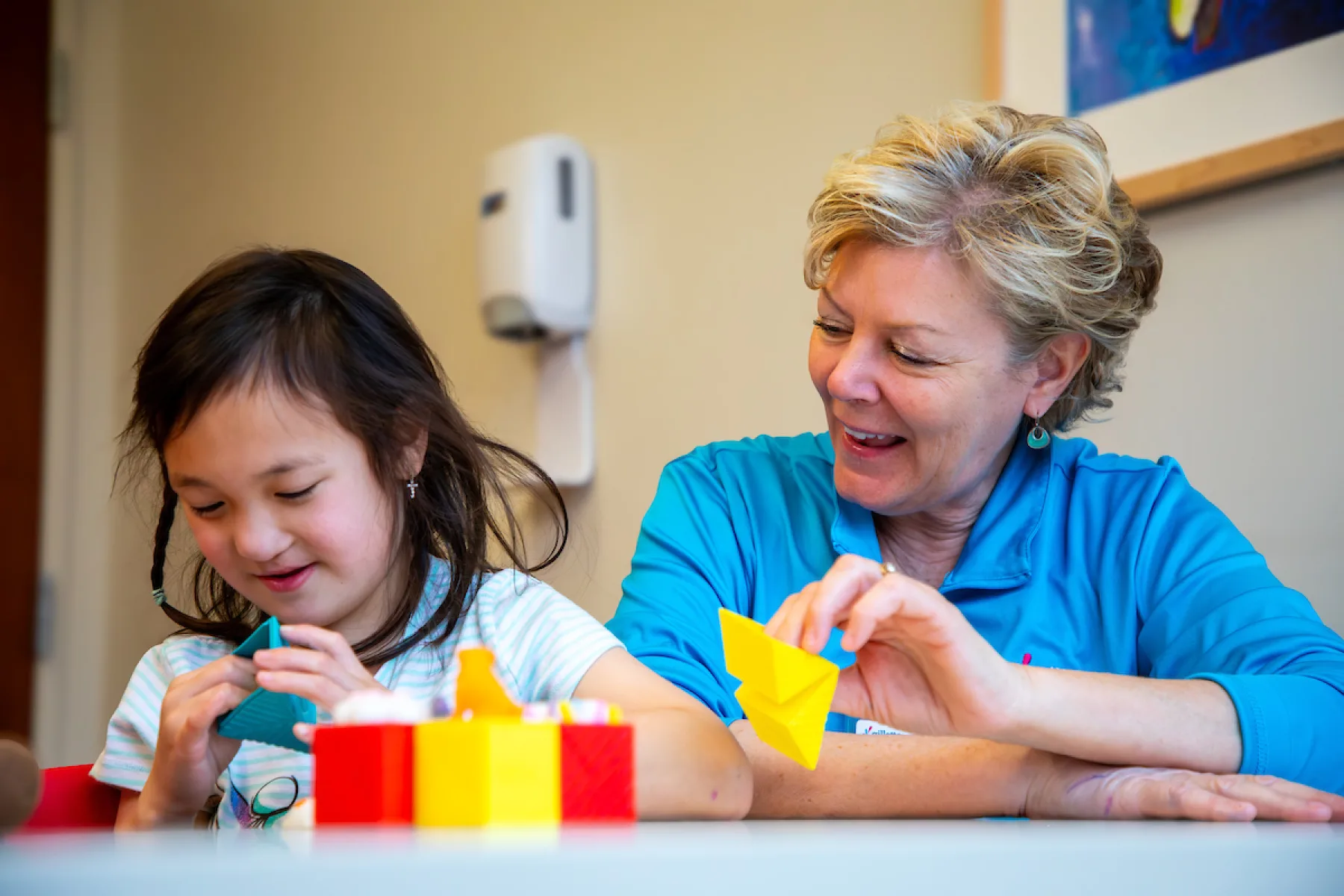 Therapist and patient playing with blocks - Gillette Children's.