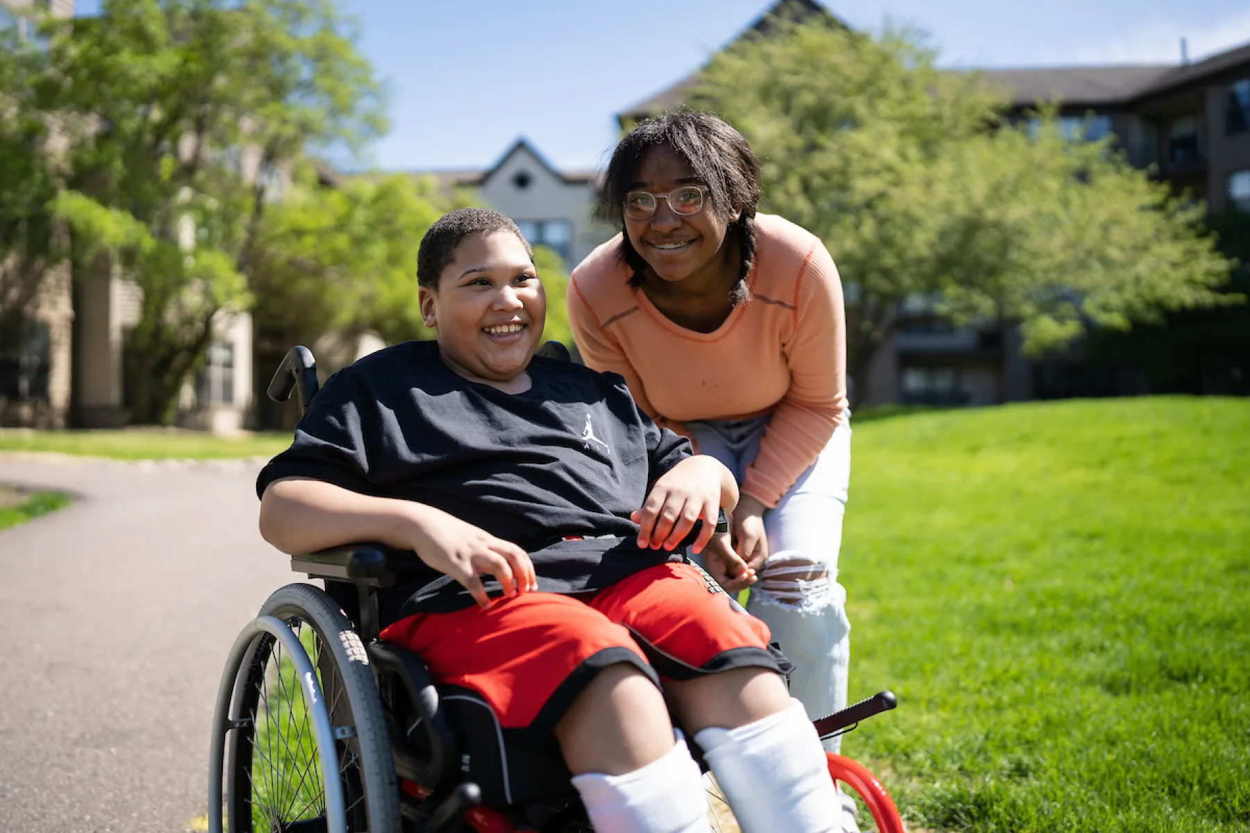 Gillette Children's patient Michael-Holley on a sunny day with his family member