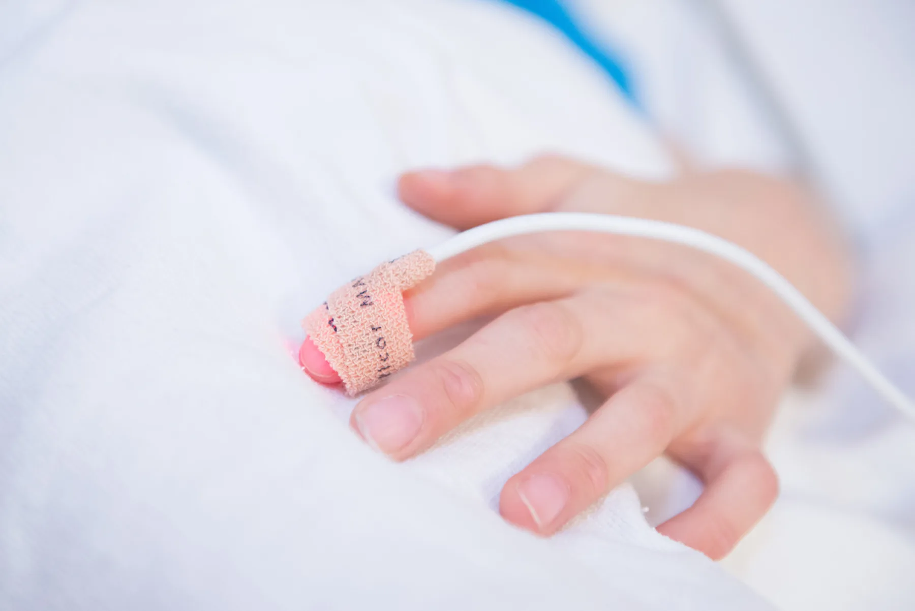 Childs hand with monitor taped to finger.