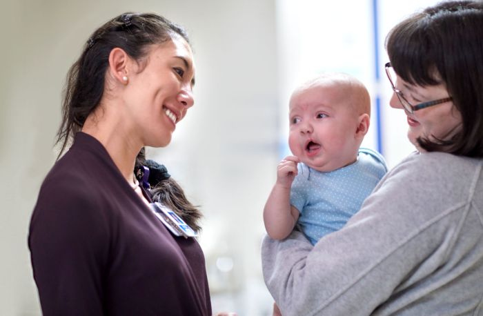 Jo Barta smiles at baby at Gillette Children's.