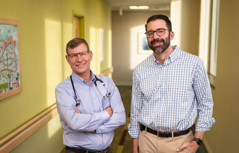 Dr. Beisang and Dr. Feyma smile in hallway at Gillette Children's.