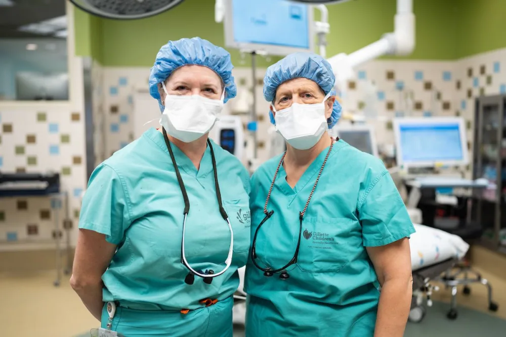 Orthopedic surgeons, Deborah Bohn, MD and Ann Van Heest, MD often do surgeries together on the same child, they pose for photo at Gillette Children's.