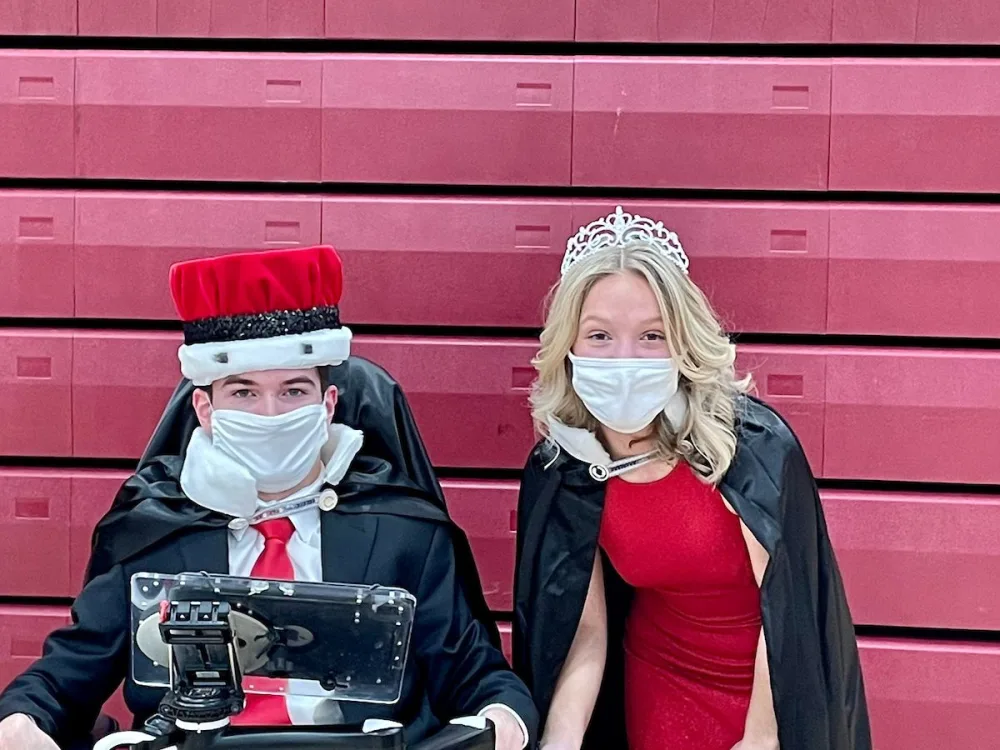Joe Carr is crowned "Fire and Ice" King at Richfield High School and smiles with friend with Gillette Children's.