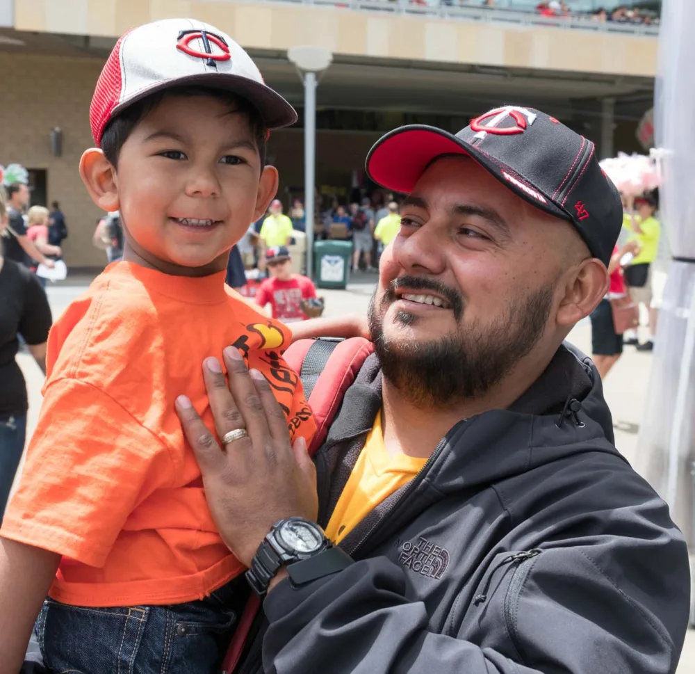 Mateo smiling at Twins game with Gillette Children's.
