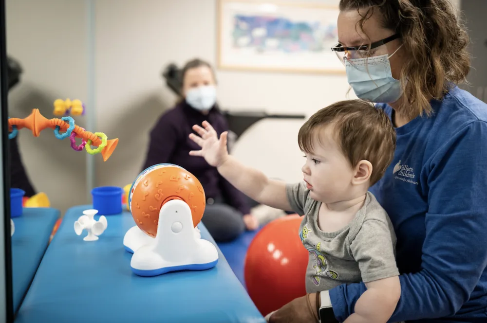 Patient and provider working through physical therapy at Gillette Children's.