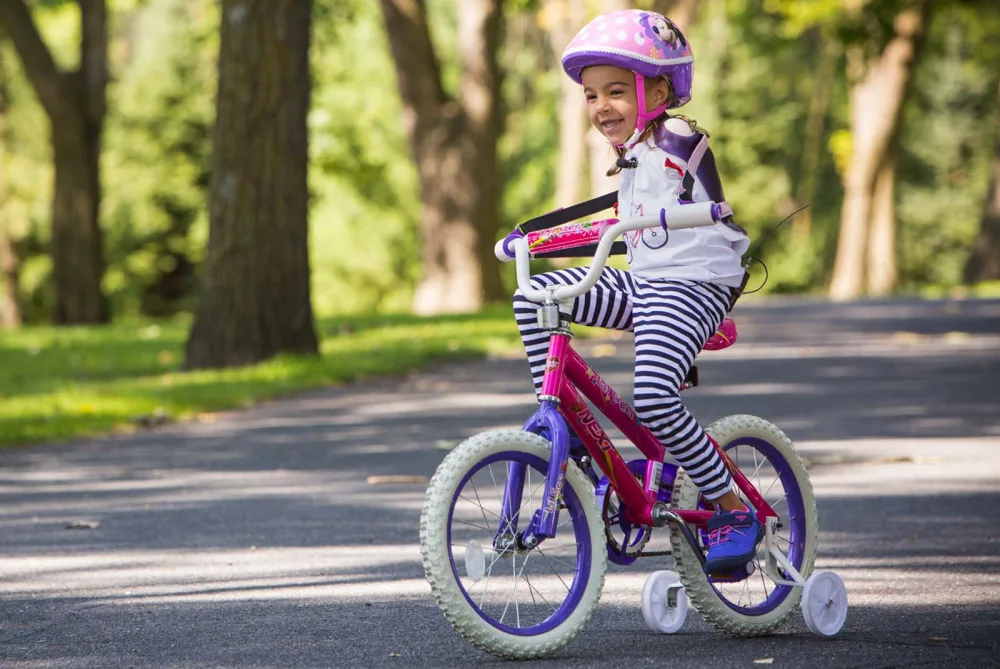Ruth Evelyn rides her bike at Gillette Children's.
