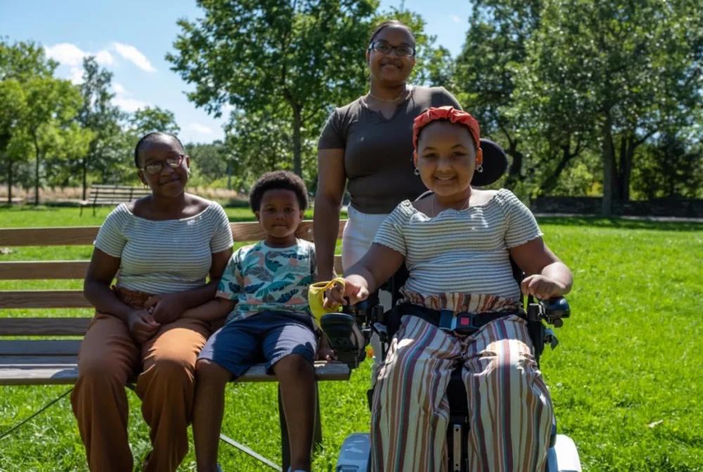 Photo of ZaNii and family at the park with Gillette Children's.
