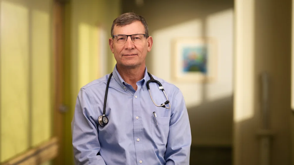 Arthur Beisang, MD, poses for a portrait in a hallway at Gillette Children's.