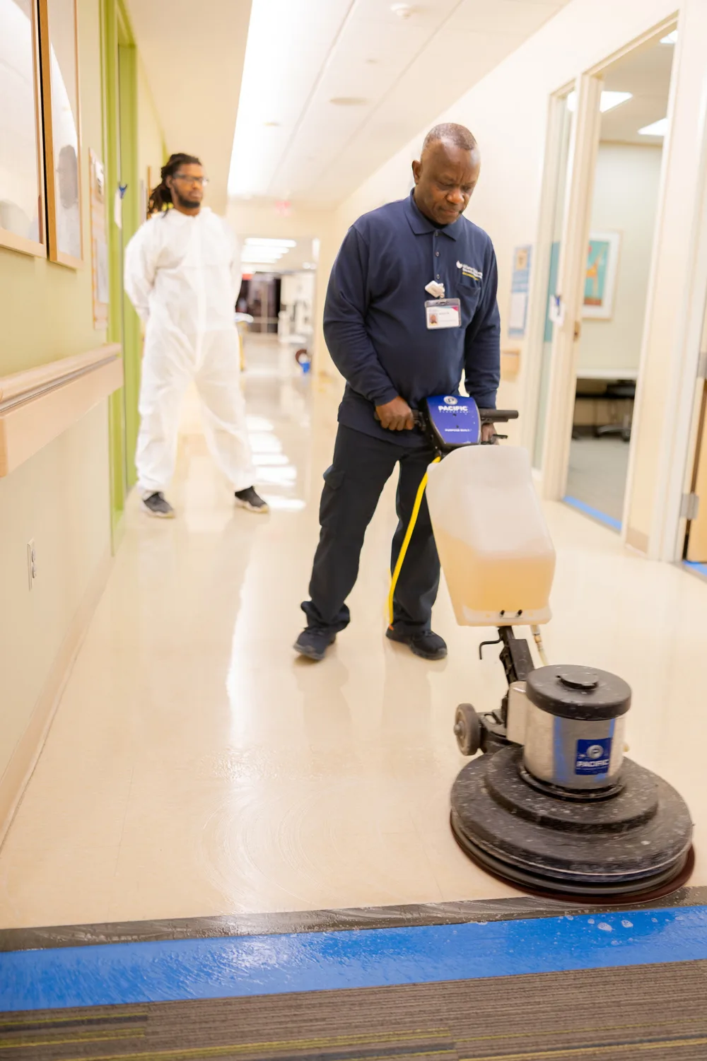 Gillette staff member Arthur Moore uses a machine to polish the floors.