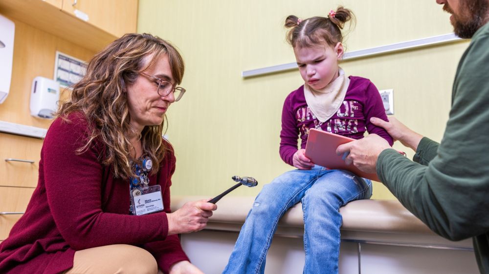 Dr. Nicole Williams Doonan performs an exam on Lilah, a Gillette Children's patient who has epilepsy.