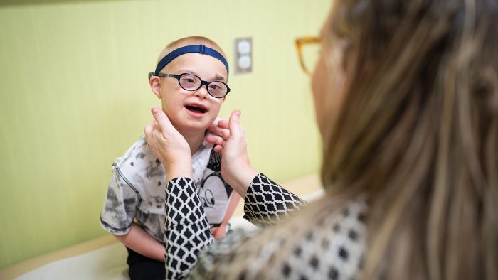 Gillette patient Peter Collins smiles as he is examined by a Gillette provider.