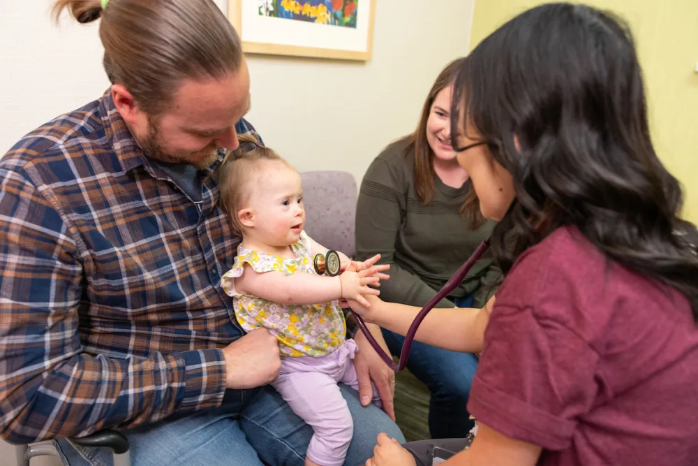 A family meets Dr. Truong in a Gillette Children's exam room.