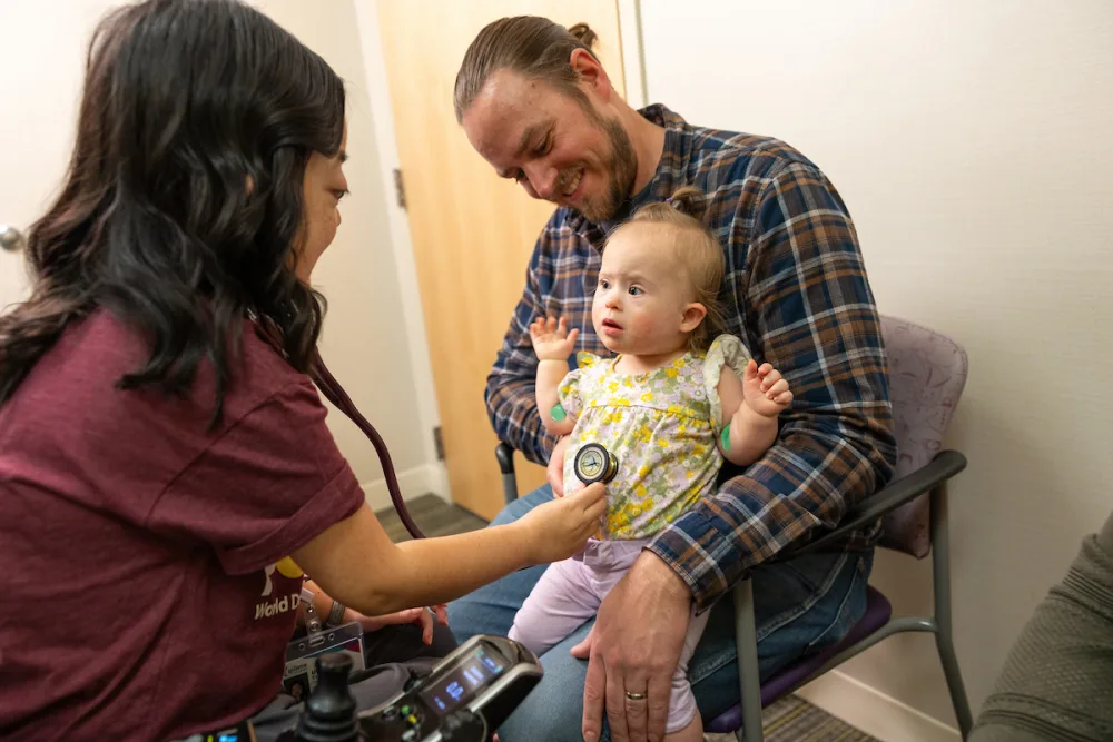 Gillette Children's patient with parent and provider in a clinic room.