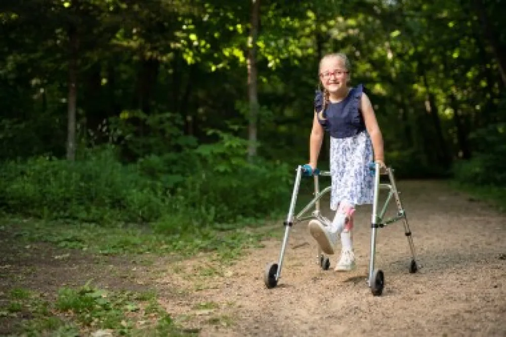Gillette Children's patient, Kate Harkness, using a walker while touring the Lowry Nature Center.