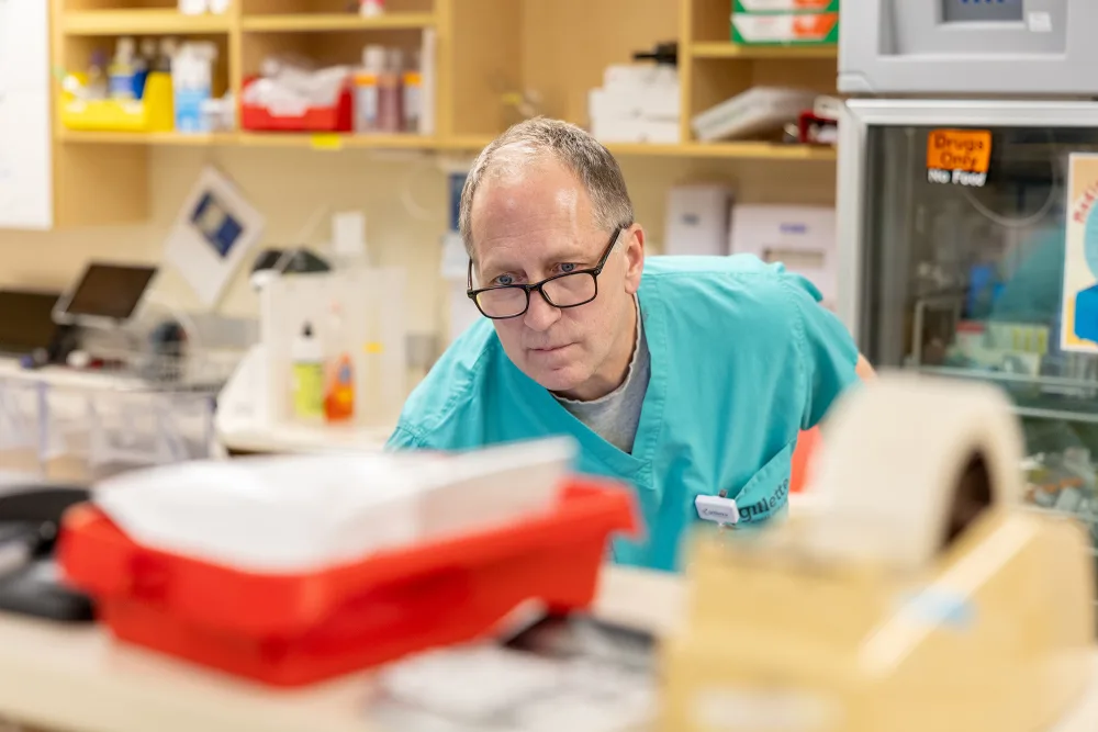 Pharmacist examining materials on a table  - Gillette Children's.