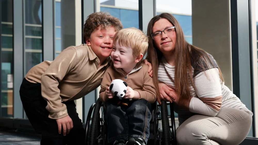 Maverick (center) with his brother, Luke (left), and his mom, Kimberly (right)