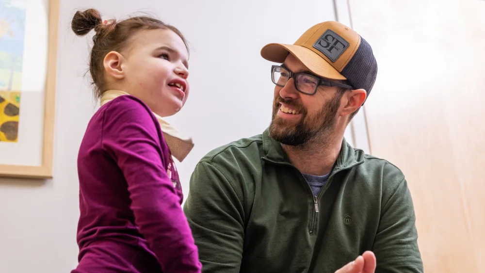 Lilah Schwab and her father Ryan smile at the Ketogenic Diet Clinic at Gillette Children's.