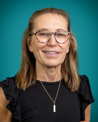 Portrait of Ann Schminski smiling.
