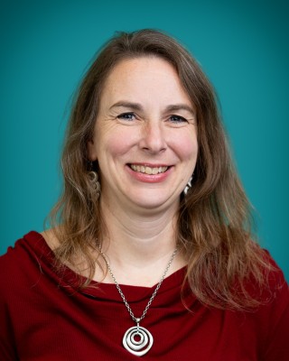 Portrait of April Shaack smiling.