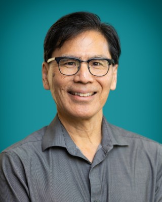 Portrait of Dr. Marshall Taniguchi smiling.