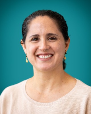 Portrait of Dr. Paola Toussaint Gonzalez smiling.