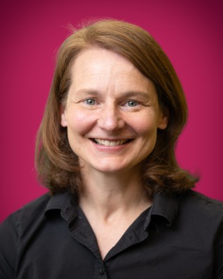 Portrait of Jean Kelecic smiling.