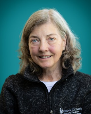 Portrait of Jean Stansbury smiling.