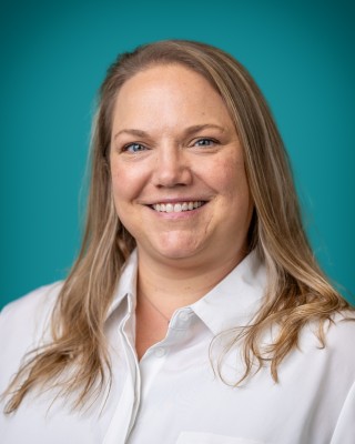 Portrait of Maggie Cutter smiling.