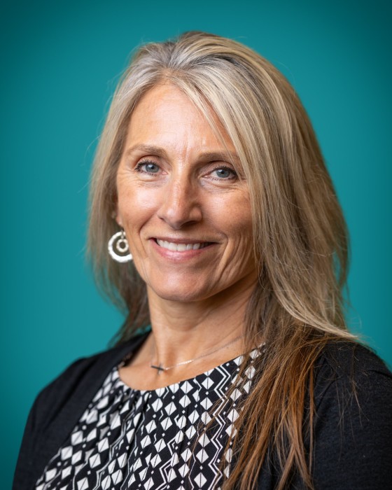 Portrait of Denise Leighty smiling.