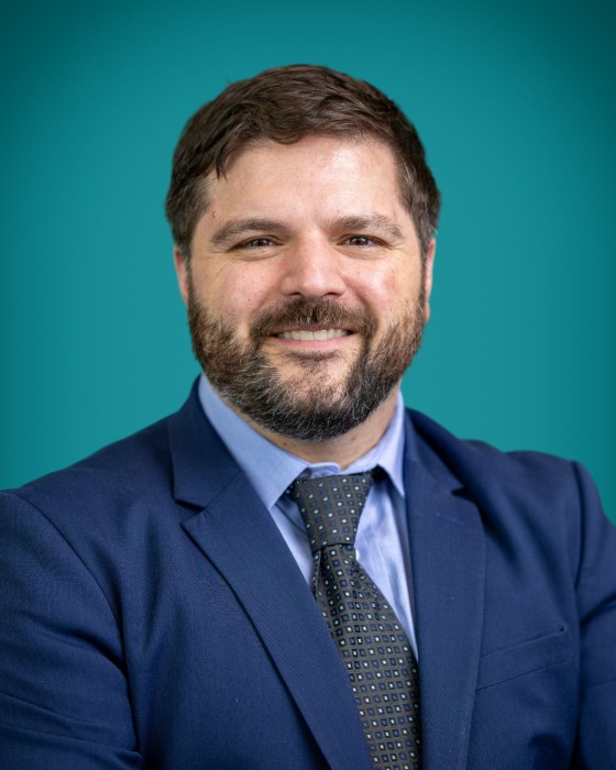 Portrait of Dr. Brian Mendes, MD smiling.