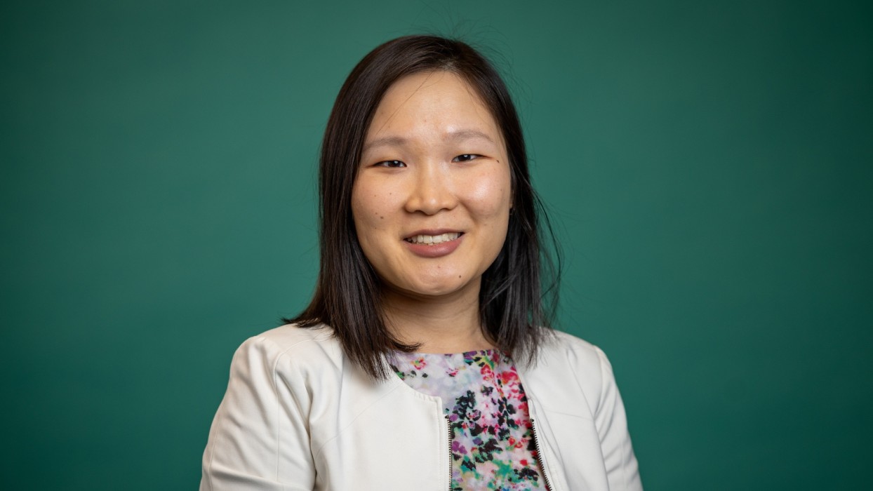 A portrait of Dr. Rosemary Ramp against a green background.