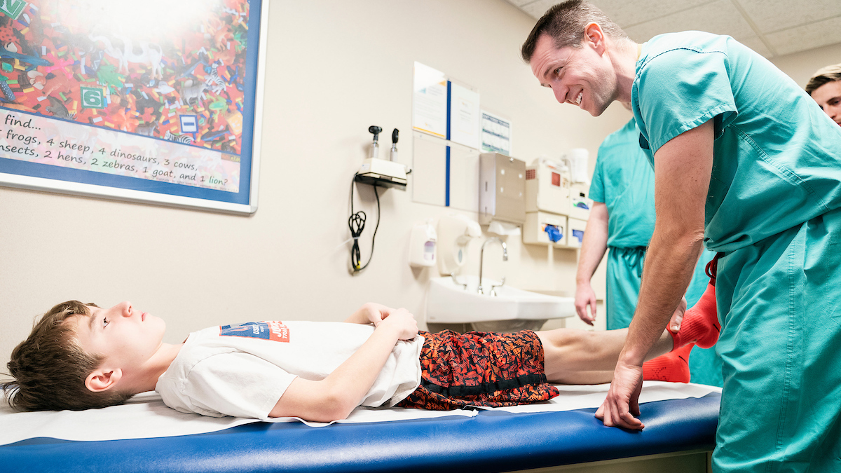 Dr Cooper with Gillette Children's patient Isaac Jacobson during an  appointment.