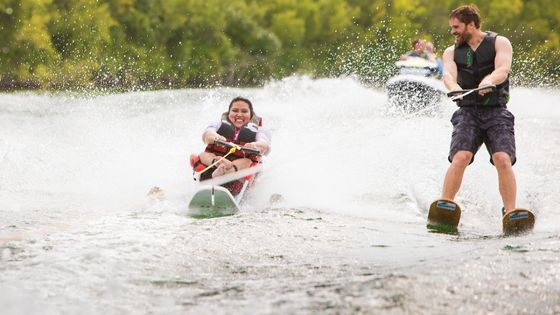 Two water skiers on a lake.