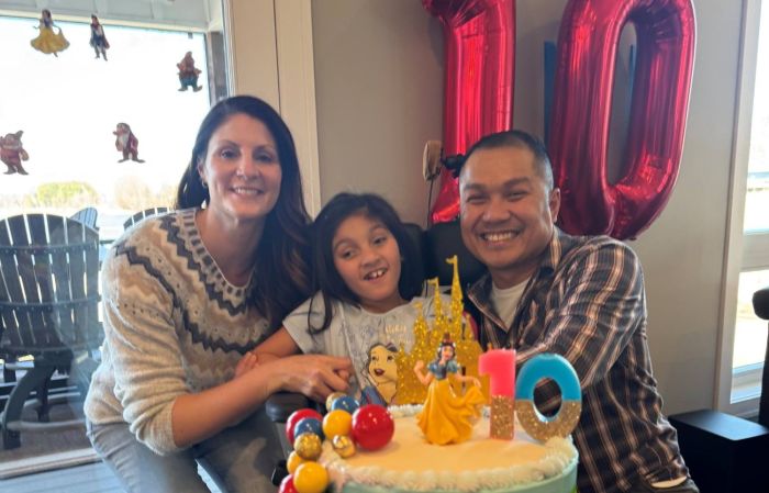 Gillette Children's patient Hazel Kim poses with her parents on her tenth birthday.