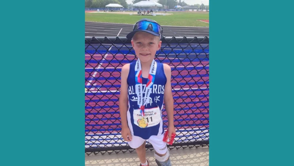 Boy wearing medals - Gillette Children's.