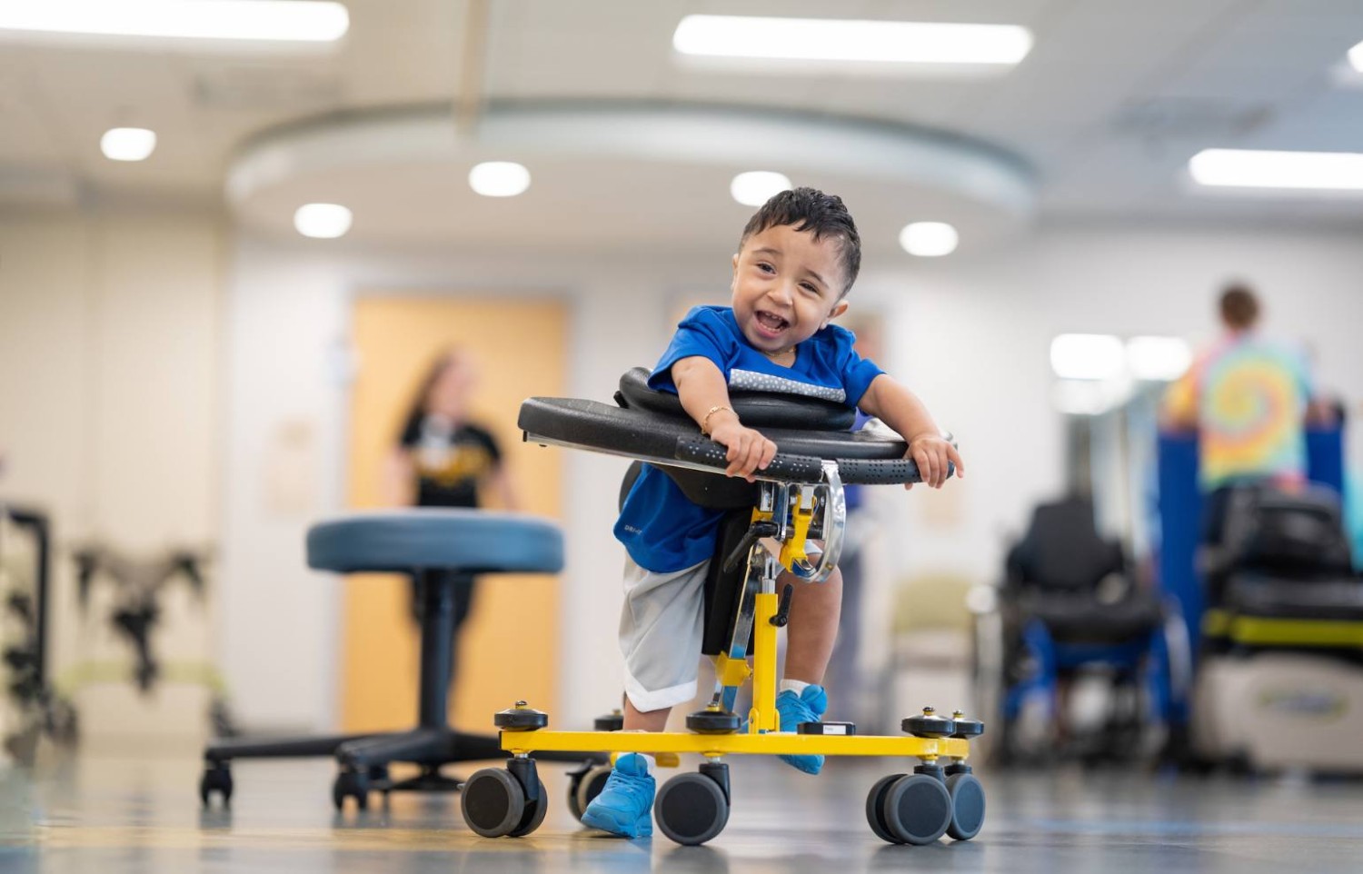 Patient Ernesto Prieto uses an adaptive walker during a rehabilitation therapy session at Gillette Children's.