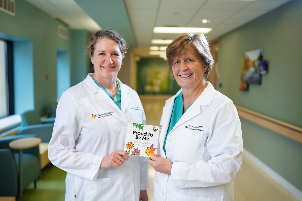 Gillette orthopedic surgeons, Deborah Bohn, MD and Ann Van Heest, MD, hold a copy of their new book.