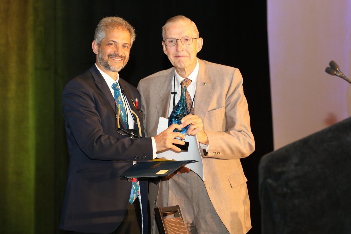 Jim Gage, MD, accepts his award from Unni Narayanan, president of the American Academy for Cerebral Palsy and Developmental Medicine. 