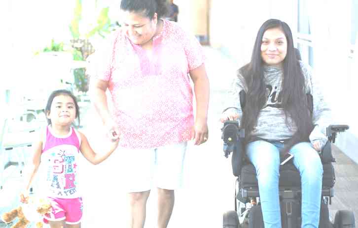 Gillette Children's spinal cord injury patient Guadalupe with her family in skyway